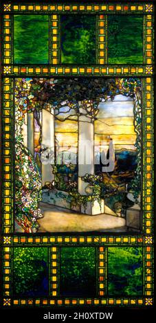 Hinds House Window , c. 1900. Tiffany Glass & Decorating Company (American, New York, 1892–1902). Leaded glass; unframed: 227.3 x 114.3 cm (89 1/2 x 45 in.).  In this window commissioned for the Howell Hinds house around 1900, thousands of richly colored glass pieces have been arranged and layered to paint an idyllic three-dimensional scene that would have warmly glowed in the afternoon sunlight. Located at 2200 Overlook Road in Cleveland, Ohio, the house was demolished in 1930 in a similar fate as other nearby estates. Photographs show the placement of the window in the drawing room next to t Stock Photo