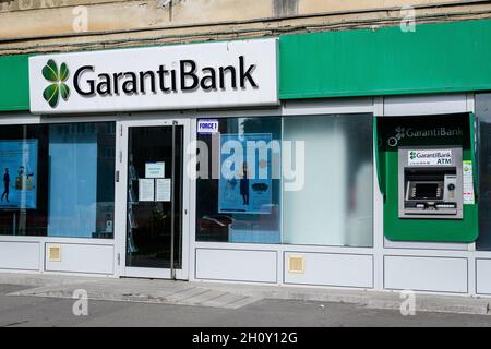 Bucharest, Romania - 24 October 2020: Main entry to a Garanti Bank branch in a historical building in downtown in a sunny autumn day Stock Photo