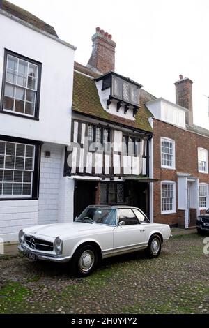 Mercedes-Benz 230 sports car parked outside half-timbered house on cobblestone Watchbell street Rye East Sussex England Great Britain UK KATHY DEWITT Stock Photo