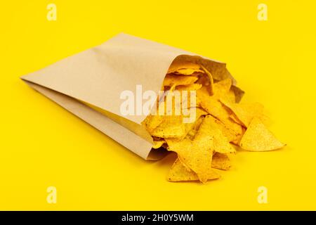 Crispy nachos chips in paper bag for convenience. Stock Photo