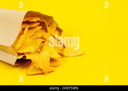 Crispy nachos chips in paper bag for convenience. Stock Photo