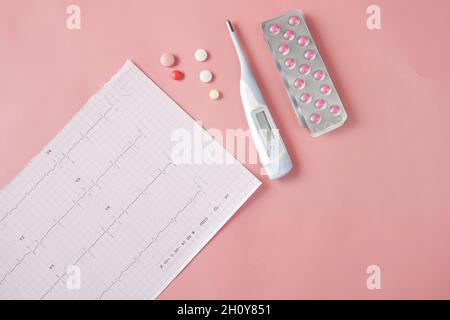 cardio diagram and medical pills on pink  Stock Photo