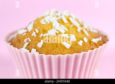 Coconut fairy cake, or cupcake, close up with pink background Stock Photo