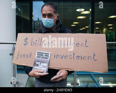 London, England, UK 15 October 2021 Extinction Rebellion 'Dirty Scrubbers' clean the outside of The World Bank to draw attention to their failure on climate action and to call for the bank president David Malpass to be replaced Credit: Denise Laura Baker/Alamy Live News Stock Photo
