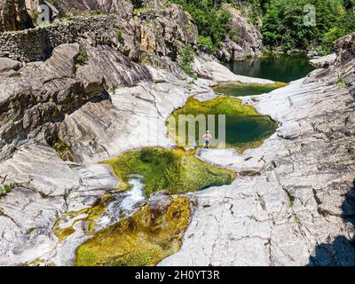Man standing in front of the Chassezac river, Lozere, Cevenne, France Stock Photo