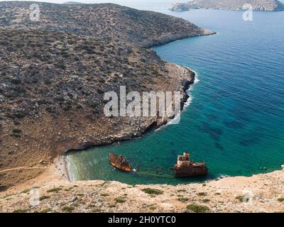 aerial drone view of Shipwreck Olympia boat in Amorgos island during summer holidays, at the coastal rocky area, people on the beach, Cyclades, Greece Stock Photo