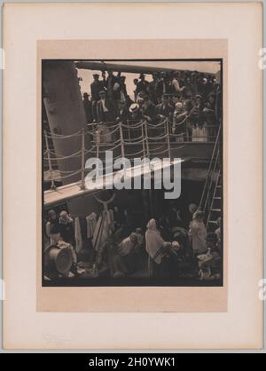 The Steerage, 1907. Alfred Stieglitz (American, 1864-1946). Photogravure; image: 32 x 25.7 cm (12 5/8 x 10 1/8 in.); image with black margin: 33.2 x 26.5 cm (13 1/16 x 10 7/16 in.); paper: 40 x 27.9 cm (15 3/4 x 11 in.); mounted: 50.8 x 38 cm (20 x 14 15/16 in.).  With his camera, Stieglitz transformed a scene of impoverished immigrants returning to Europe into a study in shape and form; the image sparked his evolution from a pictorialist into a modernist. Reflecting on his career in 1942, Stieglitz proclaimed this image, taken in 1907, as an achievement of modern art that anticipated Cubism. Stock Photo