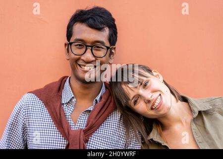 Multiracial couple having tender moments outdoor - Asiatic man and caucasian woman having fun together during erasmus - University, urban love and mul Stock Photo