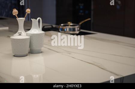 Expensive Luxury Kitchen with Stone Surface Counter and Stove in Background Stock Photo