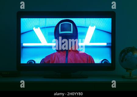 Barcelona, Spain - October 15, 2021: Television set screening a sequence of the Squid Game, the famous South Korean television series streaming on Net Stock Photo