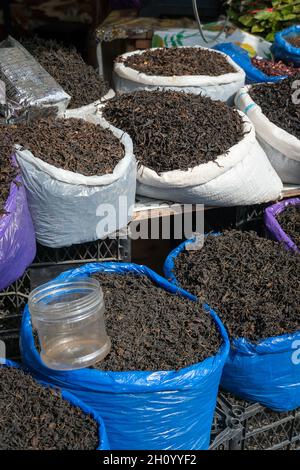 Close-up of loose Georgian tea leaves in bags on the counter at the market. Vertical photo Stock Photo