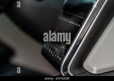 Modern car media display in the interior of the car. Touchscreen monitor on the dashboard of the modern car. Stock Photo