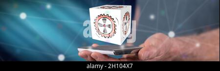 Business process concept above a smartphone held by a man Stock Photo