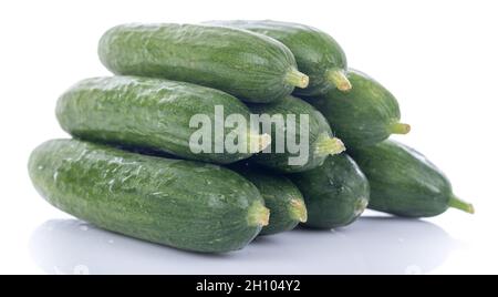 Heap of fresh mini cucumbers, isolated on white Stock Photo