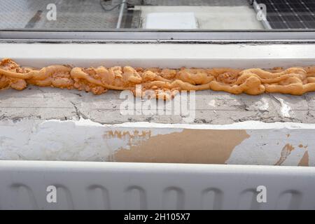 Worker using a polyurethane foam for installation of window sill. Installing window sill restoration,renovation house,building Stock Photo
