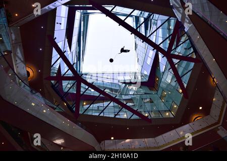 Looking up through the centre space of The Cube building with modern art sculpture floating in the middle, Birmingham, UK Stock Photo