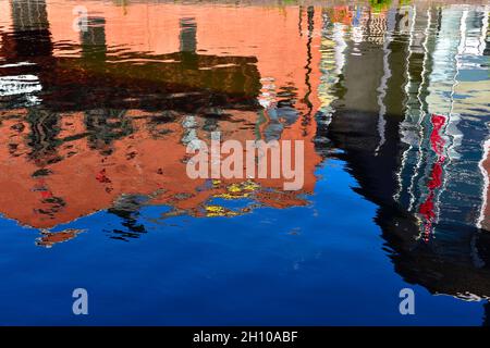 Abstract patterns of colourful building reflected on water Stock Photo