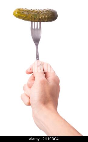 salted cucumber on a fork held by a hand isolated on white background. Clipping Path. Full depth of field. Stock Photo