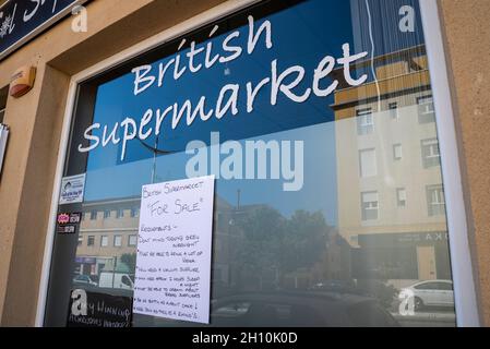 British Supermarket in Albox, Spain, advertised as a business for sale with a humorous list of requirements for potential buyers. English language Stock Photo