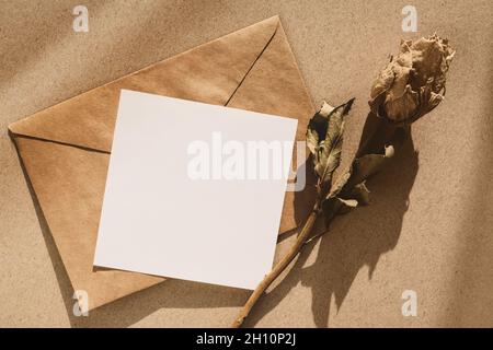 Retro mockup - brown envelope, note paper and dry flowers Stock Photo