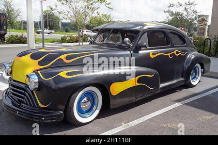 Old  1950's era Chevy hot rod Classic Car parked at a fast food restaurant. Stock Photo