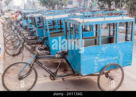 DELHI, INDIA - JANUARY 25, 2017: Cyclo rickshaws used as an alternative to a school bus for a primary school in Delhi. Stock Photo
