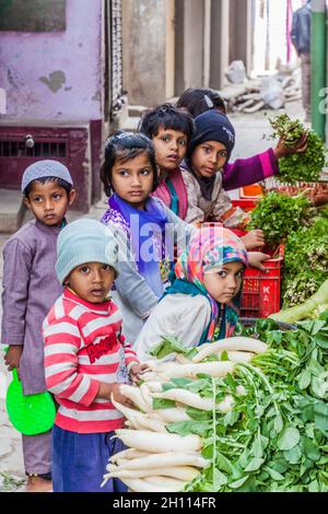 LUCKNOW, INDIA - FEBRUARY 3, 2017: Children at a vegetable stall in Lucknow, Uttar Pradesh state, India Stock Photo