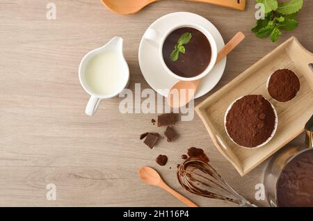 Preparing hot chocolate recipe with lingredientes on kitchen table. Top view. Stock Photo