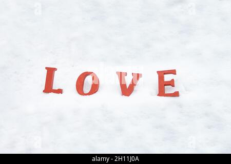 red love letters on white snow. word love on white background about-valentine friends or lovers day Stock Photo
