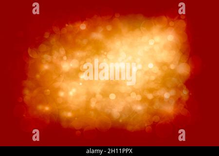 Sparkling cloud of golden Christmas party lights bokeh centered on a festive red background with copy space for use as a holiday design background Stock Photo