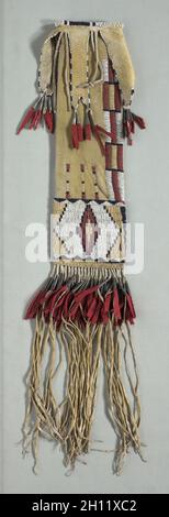 Pipe Bag, c. 1870. America, Native North American, Plains, Tsitsistas (Cheyenne) people, Post-Contact. Native-tanned hide with yellow pigment, glass beads, red trade cloth, tin cones, sinew thread; overall: 71.1 x 12.7 cm (28 x 5 in.). Stock Photo