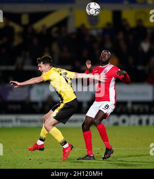 Burton Albion's Thomas O'Connor (left) and Morecambe's Toumani Diagouraga battle for the ball during the Sky Bet League One match at the Pirelli Stadium, Burton upon Trent. Picture date: Friday October 15, 2021. Stock Photo