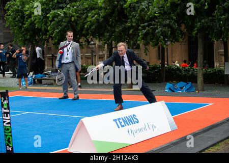 London, UK. 26th June, 2019. Sir David Amess MP for Southend West meets representatives from the Lawn Tennis Association at Parliamentary Event at New Palace Yard in the grounds of the Palace of Westminster. The LTA has a vision to make tennis accessible to all with their Tennis Opened Up scheme over the next five years. Sir David Amess also played a spot of tennis. Obituary: Sir David was tragically stabbed to death in his constituency on Friday 15th October 2021. Sir David had been an MP since 1983. Credit: Maureen McLean/Alamy Stock Photo