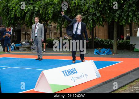 London, UK. 26th June, 2019. Sir David Amess MP for Southend West meets representatives from the Lawn Tennis Association at Parliamentary Event at New Palace Yard in the grounds of the Palace of Westminster. The LTA has a vision to make tennis accessible to all with their Tennis Opened Up scheme over the next five years. Sir David Amess also played a spot of tennis. Obituary: Sir David was tragically stabbed to death in his constituency on Friday 15th October 2021. Sir David had been an MP since 1983. Credit: Maureen McLean/Alamy Stock Photo