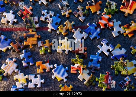Colorful puzzle flat lay separated pieces kept on floor, indoor games concept, Colorful Background Stock Photo
