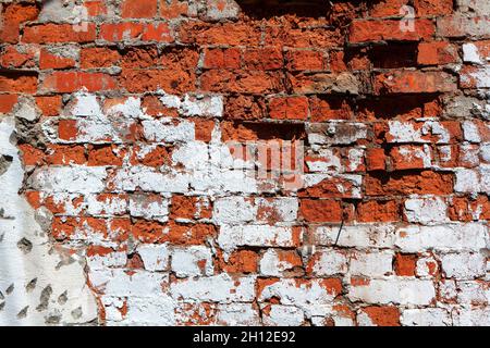 Damaged brick wall . Red and white bricks surface Stock Photo