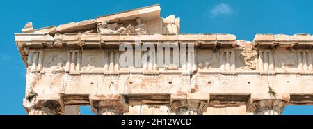 Ancient Greek temple of Parthenon on Acropolis, Athens, Greece. It is top landmark of Athens. Panoramic banner with old marble relief. Concept of past Stock Photo