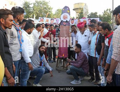 Beawar, India. 15th Oct, 2021. Congress activists burn a Ravana effigy with photos of Indian Prime Minister Narendra Modi, Home Minister Amit Shah, RSS chief Mohan Bhagwat, Uttar Pradesh Chief Minister Yogi Adityanath, Haryana Chief Minister Manohar Lal Khattar, Bharatiya Janata Party president J.P. Nadda and other BJP union ministers during their protest at Mahatma Gandhi circle in Beawar. (Photo by Sumit Saraswat/Pacific Press) Credit: Pacific Press Media Production Corp./Alamy Live News Stock Photo