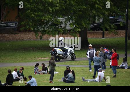 Sydney, Australia. 16th October 2021. As part of the freedom movements, a Sydney United in Prayer event was held at Camperdown Memorial Rest Park, Newtown. People also assembled in Parramatta and Canterbury/Bankstown. Pictured: A police motorcycle rides past the gathering. Credit: Richard Milnes/Alamy Live News Stock Photo