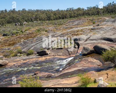 Hovea Falls on the Jane Brook in John Forrest National Park, near Perth in Western Australia, cascades down a large granite sheet. Stock Photo