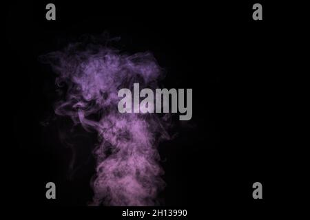 Curly purple, lilac steam, Fog or smoke isolated transparent special effect on black background. Abstract mist or smog background, design element for Stock Photo