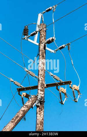 electric power distribution pole components closeup against a blue sky Stock Photo