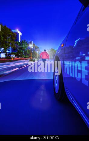 Police Sedan car speeding in the night through traffic lights, chasing a thief motion blur, Gaborone, Botswana, Stock Photo