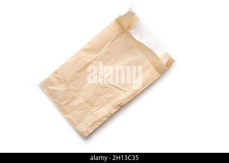 Used crumpled bag or package isolated on white. Empty food bag top view Stock Photo