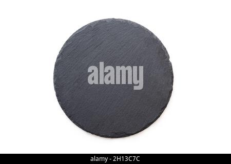 Round slate plate, black slate board isolated on white. Top view Stock Photo