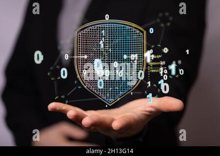 Abstract shot of a man showing data protection, security shield in digital space and on the web Stock Photo