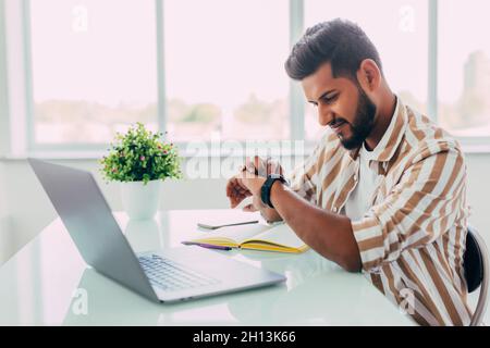 business man looking at his watch in office Stock Photo