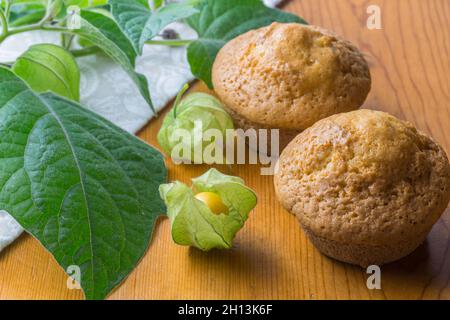 Gooseberry muffins on rustic table gooseberries in foreground Stock Photo