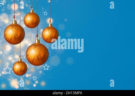 Christmas background with orange christmas balls on a blue background with diffuse lights. Selective focus. Copy space Stock Photo