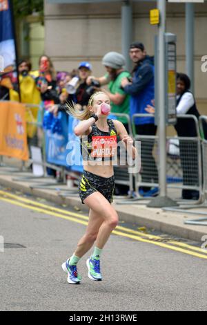 Charlotte Purdue, taking a drink, elite women's competitor, 2021 London Marathon, Canary Wharf estate, East London, United Kingdom Stock Photo